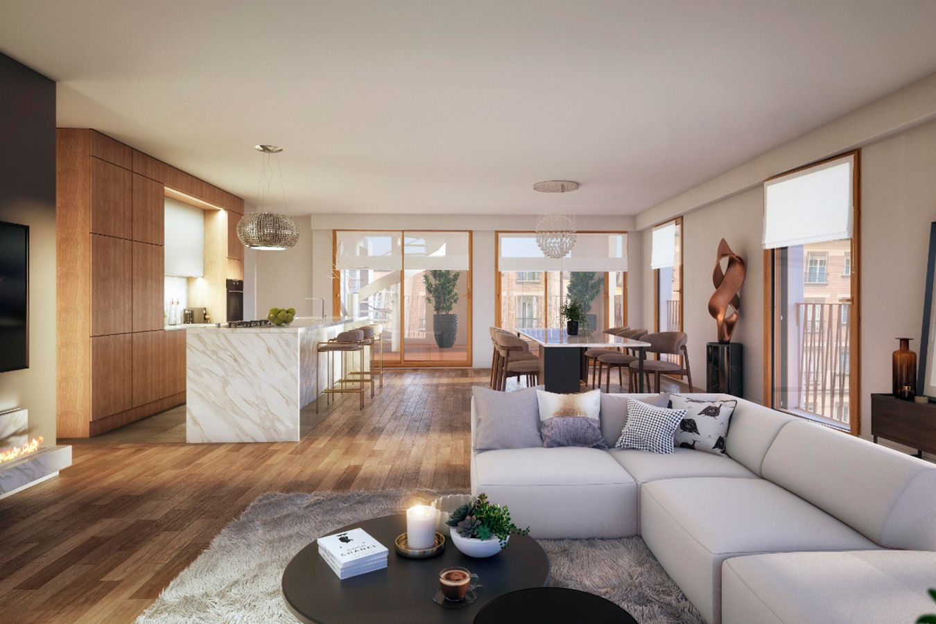Open-plan apartment with a marble kitchen island and a sofa facing a sunny balcony